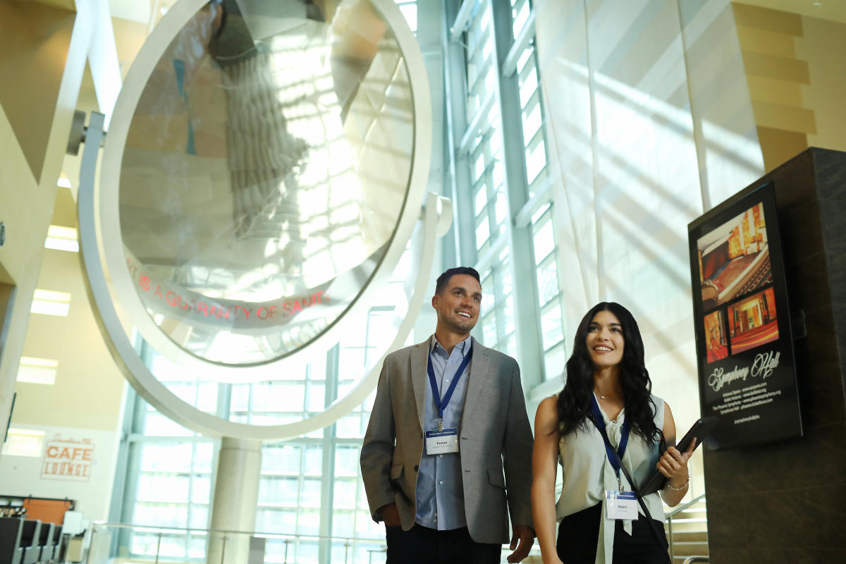 Two people walk in the Phoenix Convention Center.